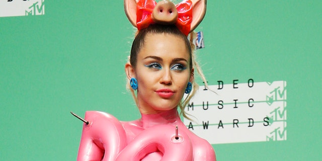 August 30, 2015. Miley Cyrus poses backstage after hosting the 2015 MTV Video Music Awards in Los Angeles, California.