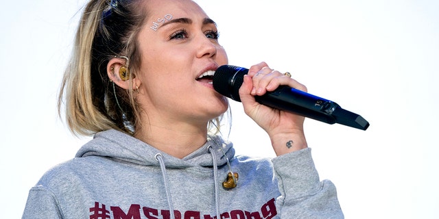 Miley Cyrus performs "The Climb" during the "March for Our Lives" rally in support of gun control in Washington, Saturday, March 24, 2018. (AP Photo/Andrew Harnik)