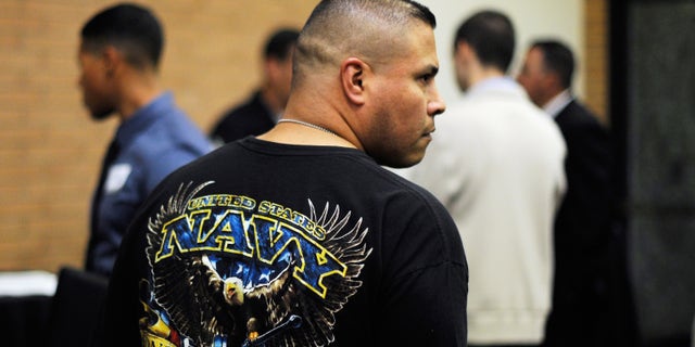 A veteran listens to a speaker as he looks at job openings during a jobs fair for veterans. (Photo by Kevork Djansezian/Getty Images)