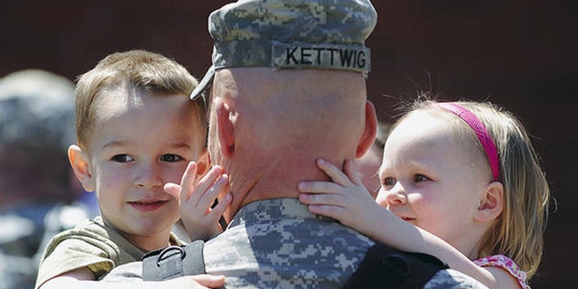 2011: Maj. Jason Kettwig of Milbank, S.D., greeted his children at a Sioux Falls, S.D., homecoming on May 3.  (Elisha Page/Argus Leader/AP)