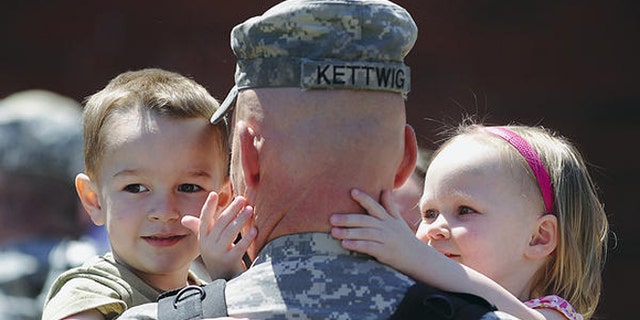 2011: Maj. Jason Kettwig of Milbank, S.D., greeted his children at a Sioux Falls, S.D., homecoming on May 3. (Elisha Page/Argus Leader/AP)