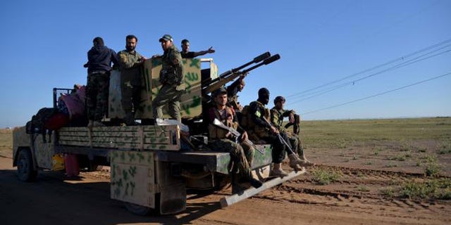 Members of the Hashid Shaabi Shia milita, one of several forces massed to retake Mosul, depart last month from Anbar to help fight ISIS.