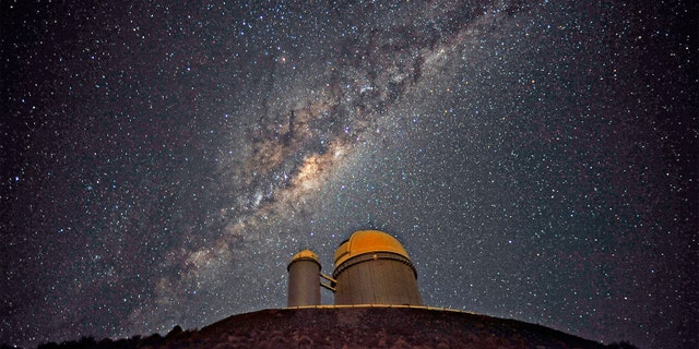 The Milky Way stretches across the sky above the La Silla telescope in Chile. Trillions of planets lurk in our galaxy, many of which have not yet been found.