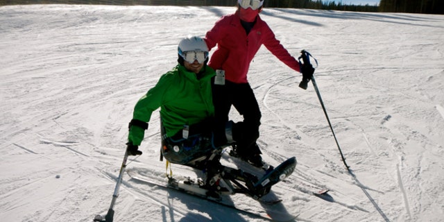 Travis Mills has 18 different prosthetic limbs, including a set that allows him to ski.