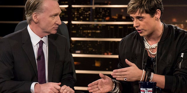 In this photo provided by HBO, host Bill Maher, left, listens to Milo Yiannopoulos, a writer for Breitbart News, on HBO's "Real Time with Bill Maher," Friday, Feb. 17, 2017, in Los Angeles. (Janet Van Ham/HBO via AP)