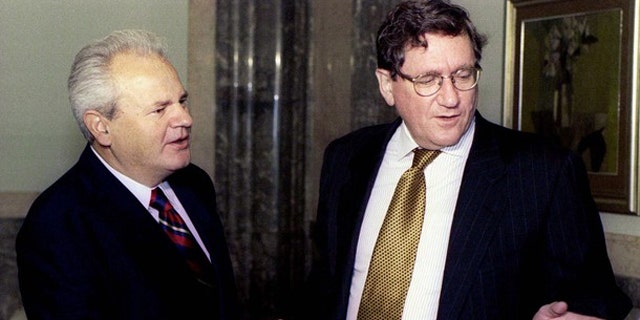 Sept. 15, 1996: Then-Serbian President Slobodan Milosevic and U.S. peace envoy Richard Holbrooke, right, shake hands at the beginning of a meeting in Belgrade. (Reuters)