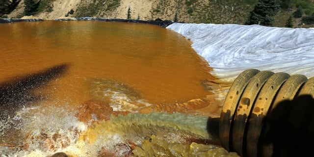 Aug. 14, 2015: Water flows through a series of sediment retention ponds built to reduce heavy metal and chemical contaminants from the Gold King Mine wastewater accident, in the spillway about 1/4 mile downstream from the mine, outside Silverton, Colo.