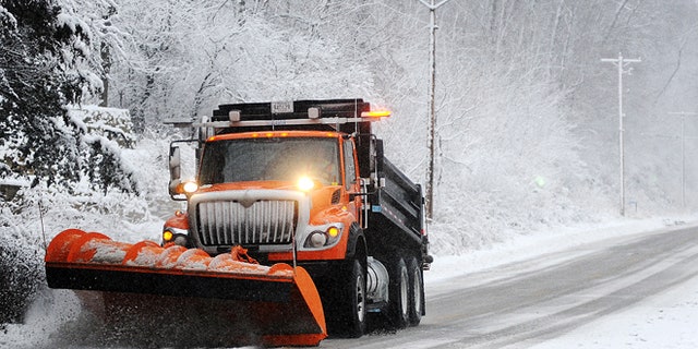 Dec. 9, 2012: A snow plow clears off Old Homer Road, near Winona, Minn. The National Weather Service is predicting a total accumulation of five to 10 inches by Monday morning.