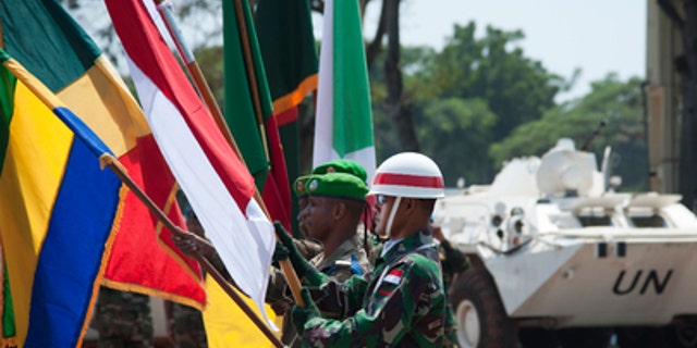 Military personnel participate in the official hand-over ceremony transitioning peacekeeping responsibilities in the Central African Republic from MISCA to MINUSCA on Sept. 15, 2014. (UN Photo/Catianne Tijerina)
