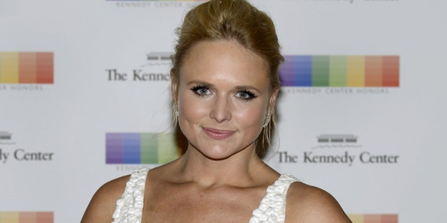 December 5, 2015. Country singer Miranda Lambert poses for photographers as she arrives for the Kennedy Center Honors gala dinner at the U.S. State Department in Washington.