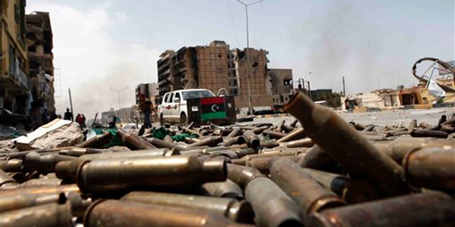 In this April 23 file photo, bullet casings litter a street in the besieged city of Misrata, Libya.