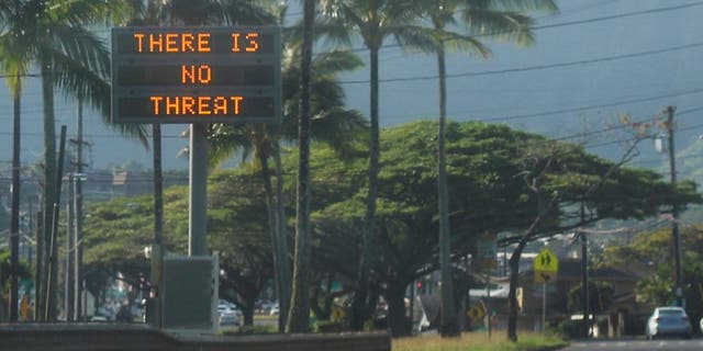 This Saturday, Jan. 13, 2018, photo provided by Jhune Liwanag shows a highway median sign broadcasting a message of "There is no threat" in Kaneohe, Hawaii.