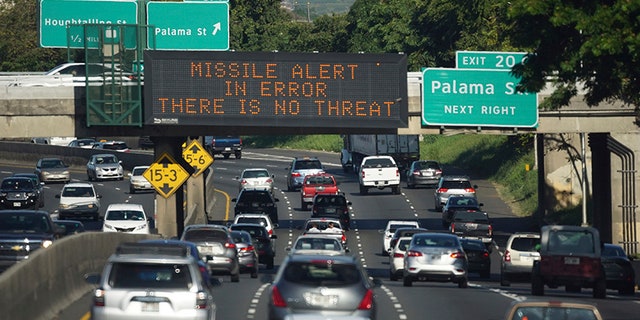 In this Saturday, Jan. 13, 2018 photo provided by Civil Beat, cars drive past a highway sign that says "MISSILE ALERT ERROR THERE IS NO THREAT" on the H-1 Freeway in Honolulu.