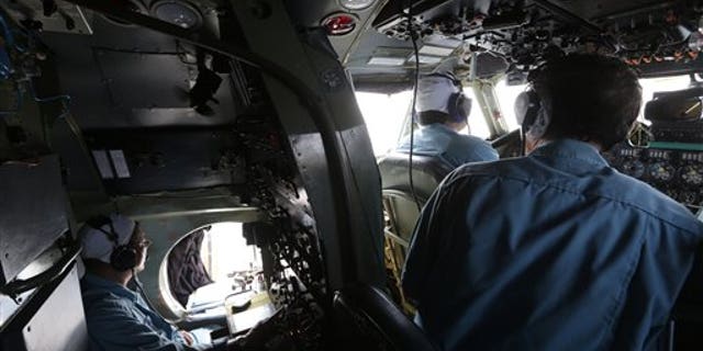 A cabin crew of Division 918 of the Vietnam Air Force is onboard a flying Soviet-made AN-26 during a search operation for the missing Malaysian Airlines Boeing 777 over the South China Sea Monday, March 10, 2014. Dozens of ships and aircraft have failed to find any piece of the missing Boeing 777 jet that vanished more than two days ago above waters south of Vietnam as investigators pursued "every angle" to explain its disappearance, including hijacking, Malaysia's civil aviation chief said Monday. (AP Photo/Na Son Nguyen)