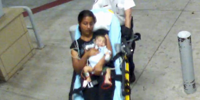 Surveillance footage shows a woman and a 2-month-old boy entering Oklahoma City hospital. Infant later disappeared and was found in Dallas. (Oklahoma City Police Department)