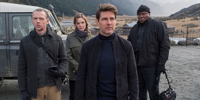 ‘Mission: Impossible 7,’ starring Tom Cruise, has halted production for two weeks after at least one production member tested positive for coronavirus. This image released by Paramount Pictures shows, from left, Simon Pegg, Rebecca Ferguson, Cruise and Ving Rhames in a scene from 2018's ‘Mission: Impossible - Fallout.’ (David James/Paramount Pictures and Skydance via AP)
