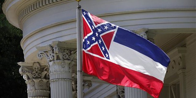 In this photo, the Mississippi state flag is unfurled against the front of the Governor's Mansion in Jackson, Miss.