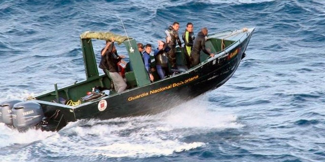 Jan. 6, 2013: In this photo provided by Venezuela's Ministry of the Interior and Justice Press Office, members of the Venezuelan National Guard search for a plane that went missing near Los Roques, Venezuela.