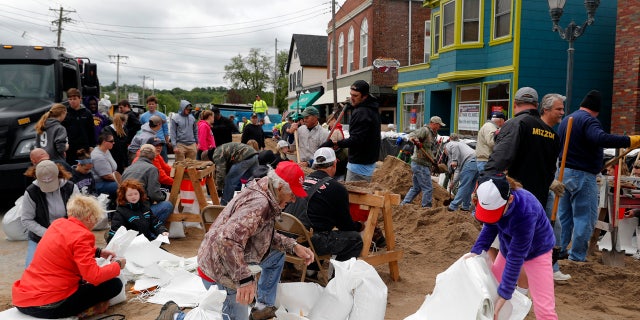 Volunteers fill sandbags in an effort to protect buildings from potential floodwater Monday, May 1, 2017, in Eureka, Mo.