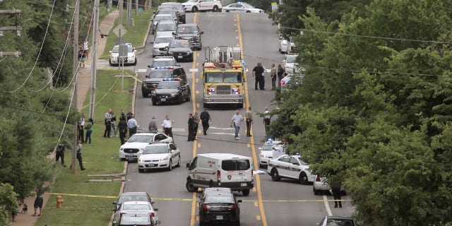 July 8, 2016: Police investigate a scene in Ballwin, Mo. after a police officer was shot during a confrontation with a man on a street.