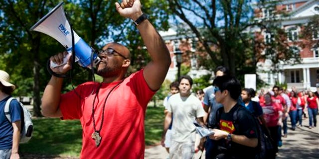 In this Aug. 26, 2015 photo, Jonathan Butler uses a megaphone during a "day of action" demonstration to draw attention to graduate students' demands in front of Jesse Hall on the University of Missouri campus in Columbia, Mo. Butler began his hunger strike on Nov. 2 to call attention to racial problems at the state's flagship university. (Daniel Brenner/Columbia Daily Tribune via AP) MANDATORY CREDIT