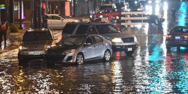 A road is blocked off as floodwaters rise in Kansas City, Mo., Aug. 26, 2016. (Tammy Ljungblad/The Kansas City Star via AP)