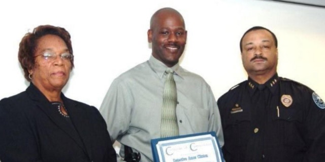 UNDATED: In this 2008 image provided by the Jackson, Miss. Police, Detective Eric Smith, center, flanked by Chief Rebecca Coleman, left, and Assistant Chief Lee Vance accepts the Certificate of Commendation on behalf of Detective Amos Clinton in Jackson, Miss.