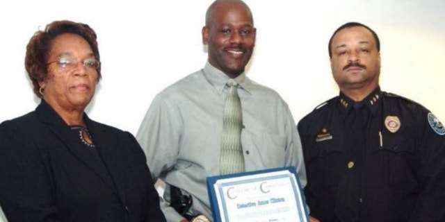 UNDATED: In this 2008 image provided by the Jackson, Miss. Police, Detective Eric Smith, center, flanked by Chief Rebecca Coleman, left, and Assistant Chief Lee Vance accepts the Certificate of Commendation on behalf of Detective Amos Clinton in Jackson, Miss.