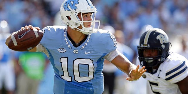 FILE - In this Sept. 24, 2016, file photo, North Carolina quarterback Mitch Trubisky (10) throws a pass as Pittsburgh's Ejuan Price (5) rushes during the first half of an NCAA college football game in Chapel Hill, N.C. Trubisky has thrown for at least 400 yards in three straight games entering Saturday's visit from No. 25 Virginia Tech. (AP Photo/Gerry Broome, File)