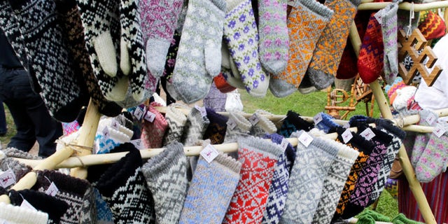 Traditional knitted mittens are displayed during an annual Traditional Applied Arts Fair in the Ethnographic Open-air Museum of Latvia in Riga, June 1, 2013. According to the organisers, the fair has more than 500 tailors, leather craftsmen, wood carvers, jewellery designers, blacksmiths, basket-makers, weavers, potters, as well as knitters from all over Latvia who will be selling their crafts from June 1 to 2. REUTERS/Ints Kalnins (LATVIA - Tags: SOCIETY TRAVEL) - RTX10864
