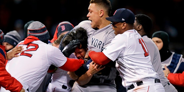 New York Yankees right fielder Aaron Judge puts Boston Red Sox relief pitcher Joe Kelly in a headlock after Kelly hit Yankees' Tyler Austin with a pitch during the seventh inning of a baseball game at Fenway Park in Boston.