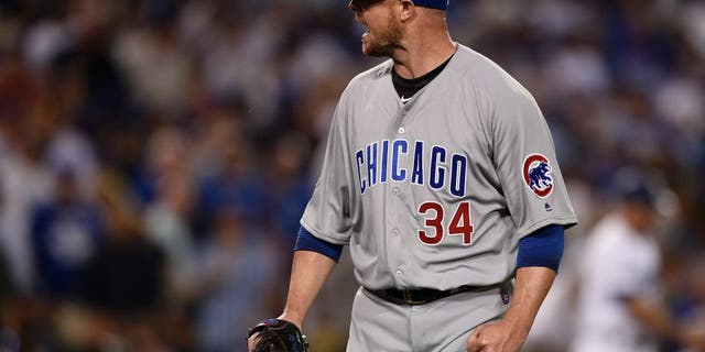 Oct 20, 2016; Los Angeles, CA, USA; Chicago Cubs starting pitcher Jon Lester (34) reacts after the third out in the third inning against the Los Angeles Dodgers in game five of the 2016 NLCS playoff baseball series against the Los Angeles Dodgers at Dodger Stadium. Mandatory Credit: Kelvin Kuo-USA TODAY Sports