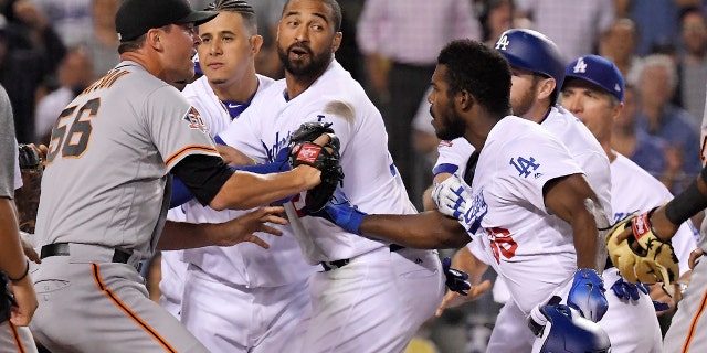 Dodgers and Giants players get in the middle of Puig and Hundley.