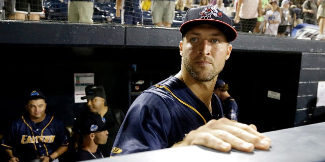 Eastern Division's Tim Tebow watches from the dugout after the Eastern League All-Star Double-A baseball game.