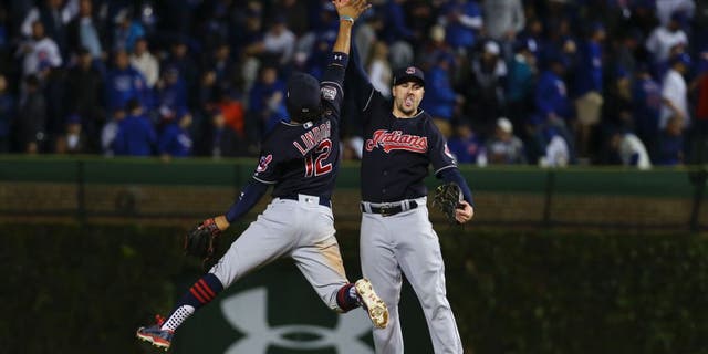 Oct 29, 2016; Chicago, IL, USA; Cleveland Indians shortstop Francisco Lindor (12) celebrates with right fielder Lonnie Chisenhall (right) after game four of the 2016 World Series against the Chicago Cubs at Wrigley Field. The Indians defeated the Cubs 7-2. Mandatory Credit: Jerry Lai-USA TODAY Sports