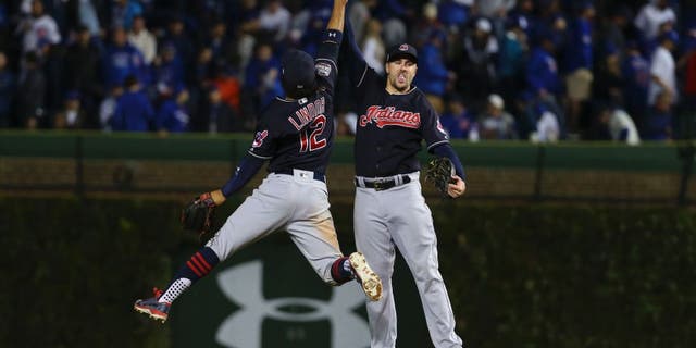 Oct 29, 2016; Chicago, IL, USA; Cleveland Indians shortstop Francisco Lindor (12) celebrates with right fielder Lonnie Chisenhall (right) after game four of the 2016 World Series against the Chicago Cubs at Wrigley Field. The Indians defeated the Cubs 7-2. Mandatory Credit: Jerry Lai-USA TODAY Sports