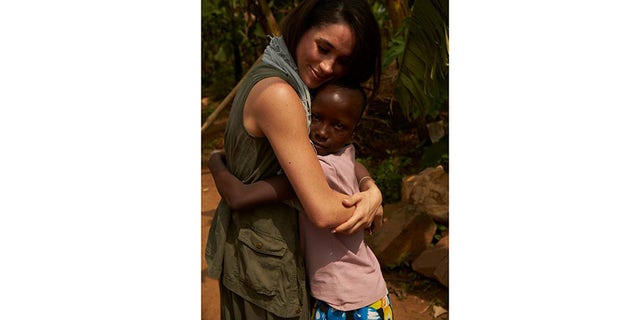 Meghan Markle hugging a child.