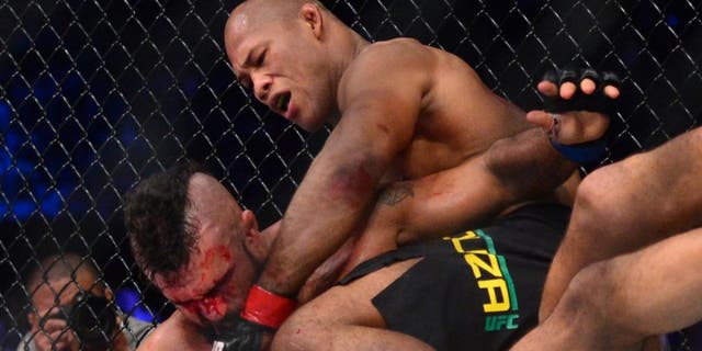 May 14, 2016; Curitiba, Brazil; Ronaldo Souza (red, top) throws punches down on Vitor Belfort (blue) during UFC Fight Night at Arena Atletico Paranaense. Mandatory Credit: Jason Silva-USA TODAY Sports