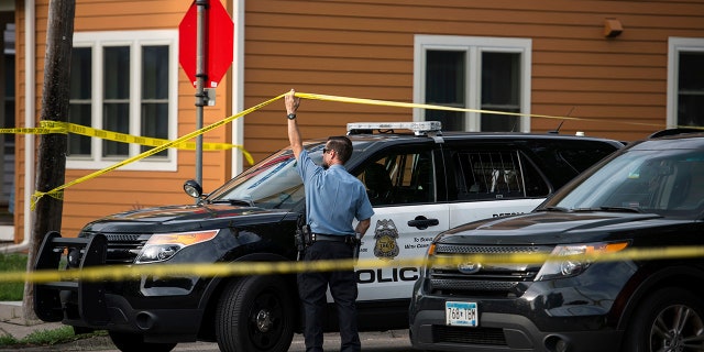 Police in Minneapolis say officers shot and killed a man who was firing a handgun as he walked down a city street.