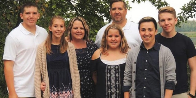 This undated photo shows the Peterson family of Ada, Minn. Carter Peterson, far left, was killed in a car crash that Randy, third from right, responded to as a volunteer firefighter