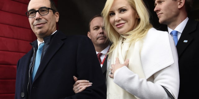 In this Friday, Jan. 20, 2017, file photo, Treasury Secretary-designate Stephen Mnuchin and his fiancee, Louise Linton, arrive on Capitol Hill in Washington, for the presidential inauguration of Donald Trump.