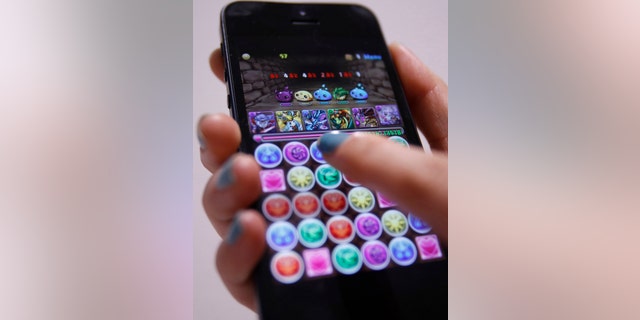 File photo: A iPhone demonstration of GungHo Online Entertainment Inc's mobile online game Puzzle and Dragons is pictured at the company's offices in Tokyo April 10, 2013. (REUTERS/Yuya Shino)