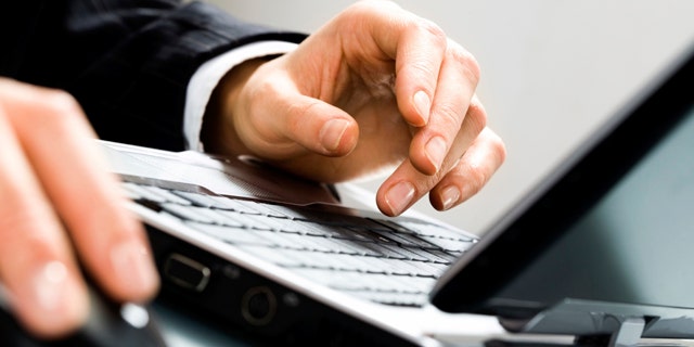 Image of human hands doing some computer work