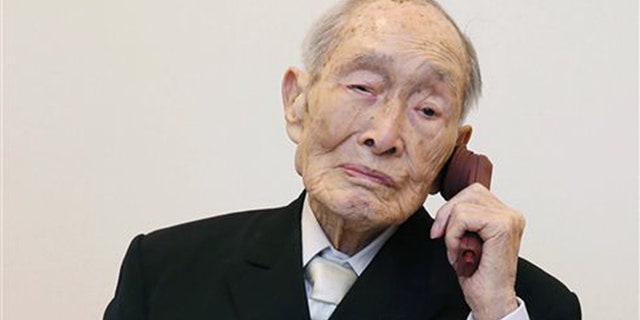 In this Aug. 20, 2014 file photo, Sakari Momoi, a Japanese retired educator, poses for a photo in Tokyo.