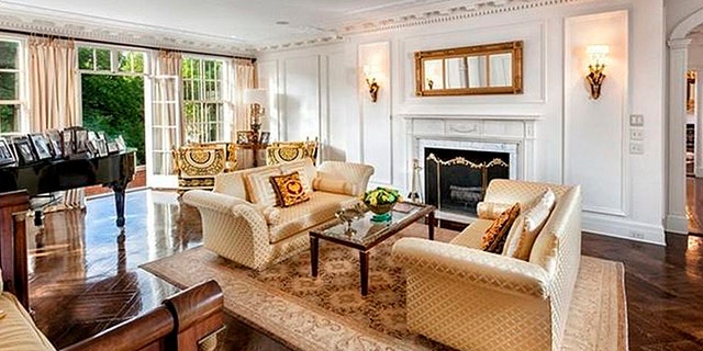 This principal room features one of the home's eight fireplaces.