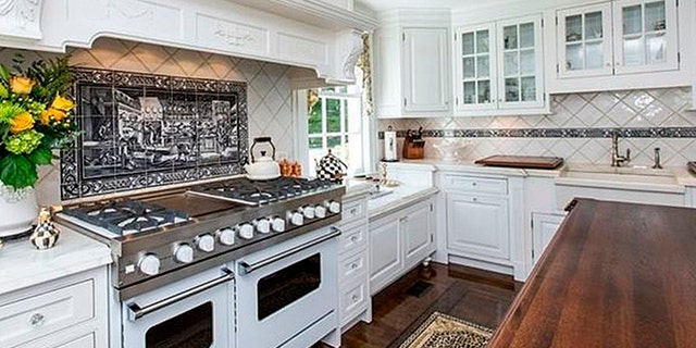 Kitchen highlights include a ten burner stove, sprawling island, and plenty of cabinet space.