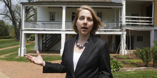 In this Thursday, April 21, 2016 photo, Executive Director of The James Monroe Highland Foundation, Sara Bon-Harper, gestures in front what was considered the home of former President James Monroe in Charlottesville, Va. The house which is shown from the back was a guest house built in 1818. (AP Photo/Steve Helber)