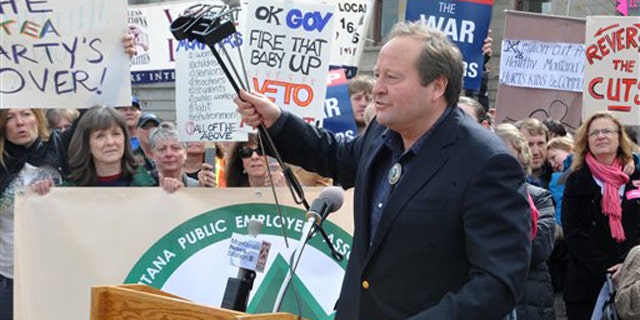 Montana Gov. Brian Schweitzer speaks in front of a crowd of protesters outside the Capitol in Helena, Mont., on April 1.