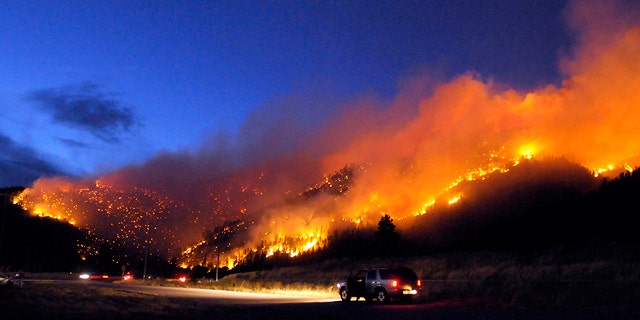 Aug. 22: Flames light up the evening sky near Missoula, Mont., as a wildfire burns through timber.