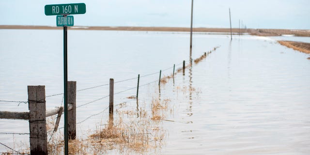 A pasture lays submerged under five to 15 feet of water at the Gildford Colony north of Gildford, Mont